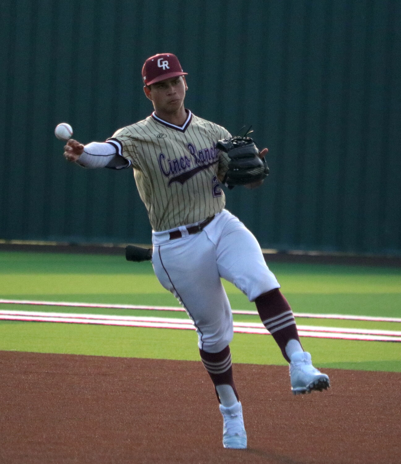 Rainer Castillo makes a throw to first base during Friday's Regional Quarterfinal between Cinco Ranch and Ridge Point at Langham Creek.