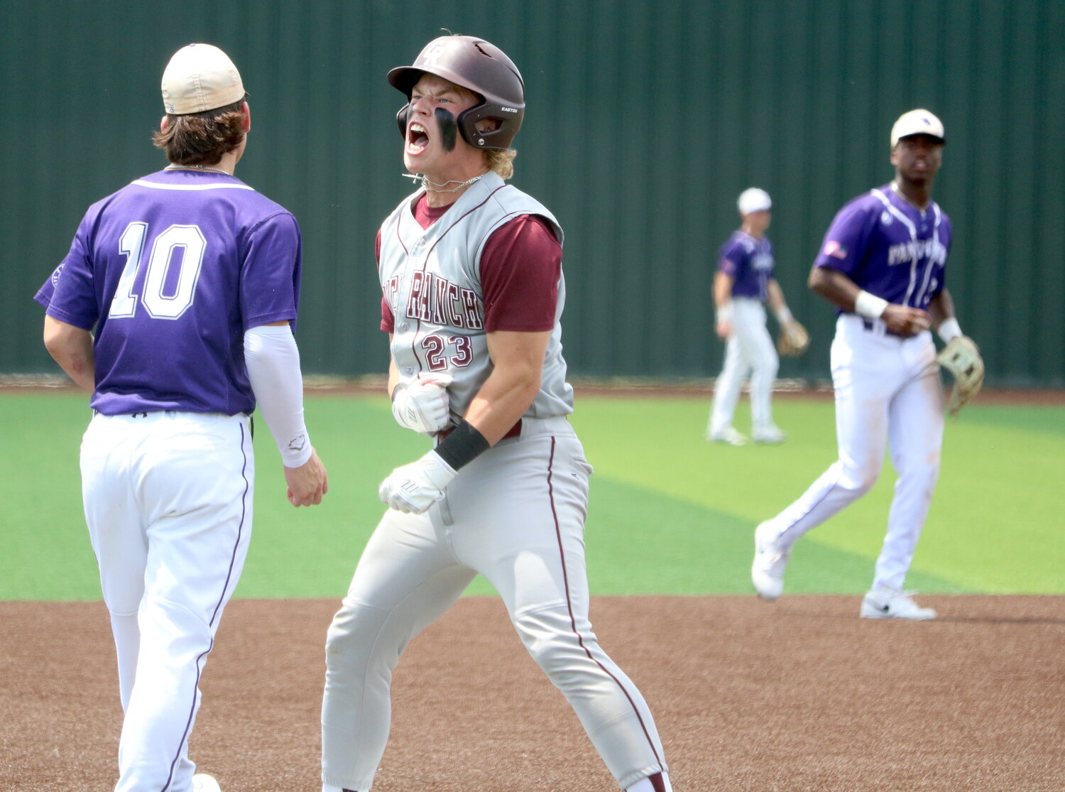 Logan Sosolik celebrates after hitting a triple during Saturday's Regional Quarterfinal between Cinco Ranch and Ridge Point.