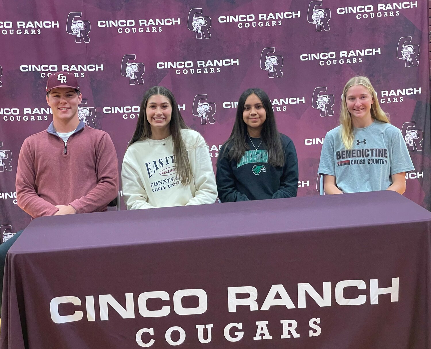 Cinco Ranch's Ryan Sidener, Sofia Budnik, Elizabeth Campos and Helen Ullrich pose for a photo after signing their National Letter's of Intent to play sports at the collegiate level.