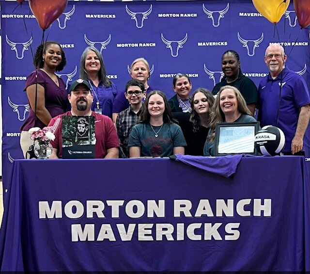 Morton Ranch's Hadley Hyle poses for a photo after singing their National Letters of Intent.