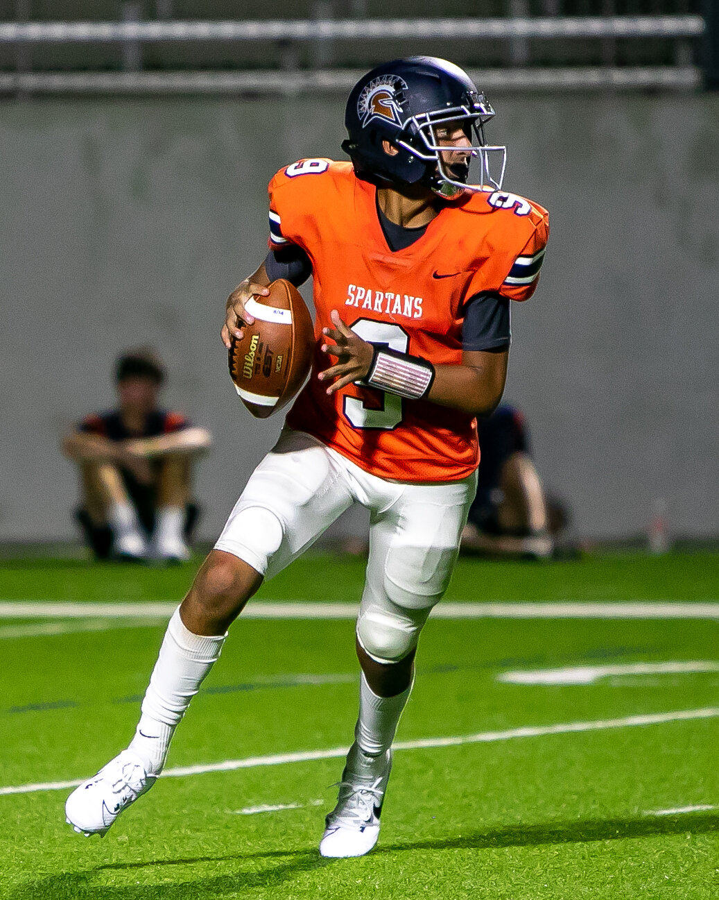 Shaan Patel rolls out from the pocket during Thursday's game between Seven Lakes and Memorial at Legacy Stadium.
