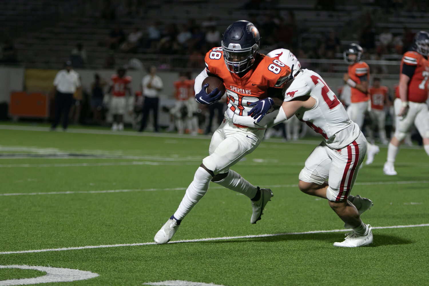 Ryan Fowler fights through a tackle during Thursday's game between Seven Lakes and Memorial at Legacy Stadium.