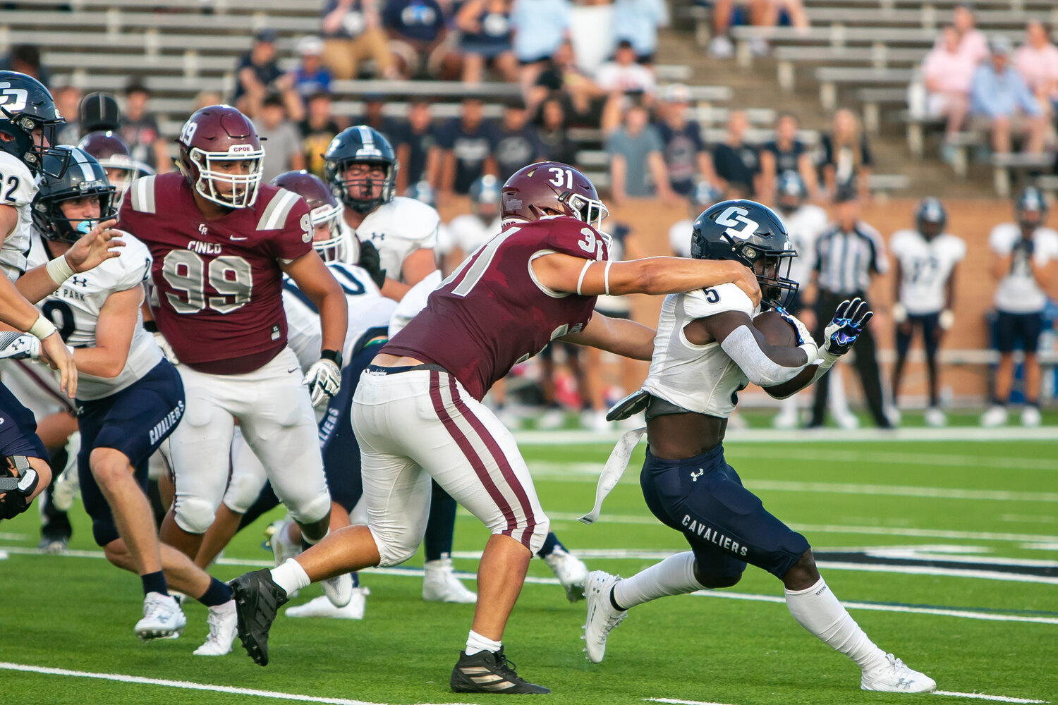 Ari Abel takes down College Park's Eugene Burnett during Friday's game between Cinco Ranch and College Park at Rhodes Stadium.