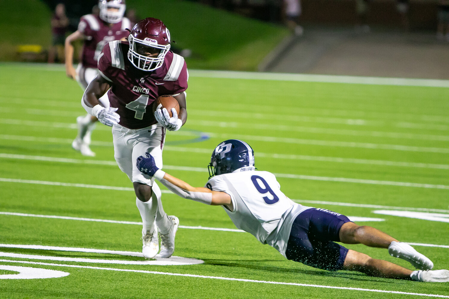 Tessiah Young breaks a tackle during Friday's game between Cinco Ranch and College Park at Rhodes Stadium.