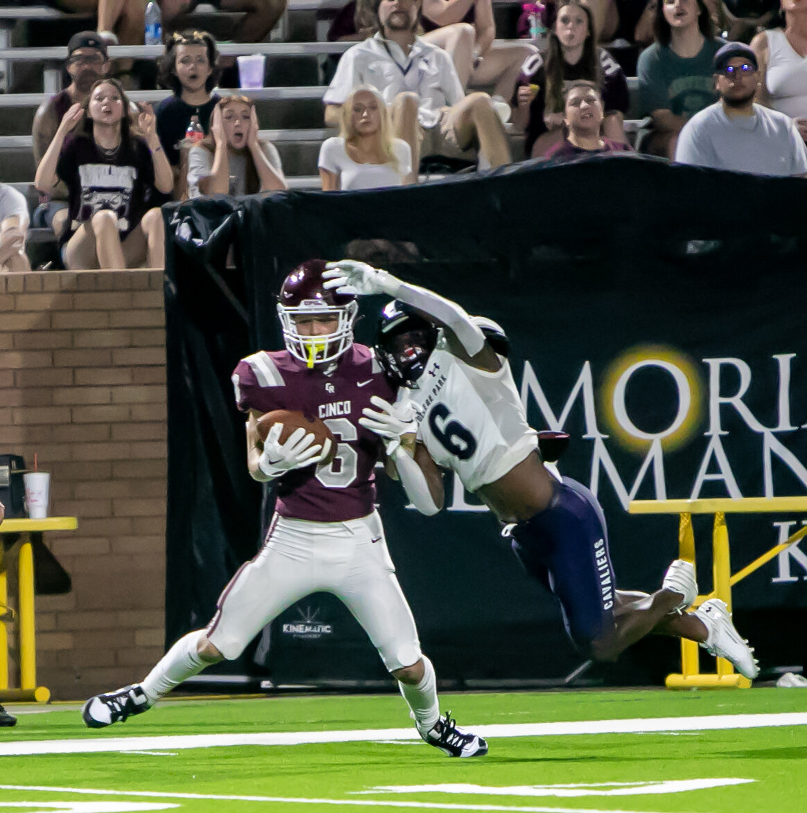 Scott Eckel hauls in a one-handed catch on the sideline during Friday's game between Cinco Ranch and College Park at Rhodes Stadium.