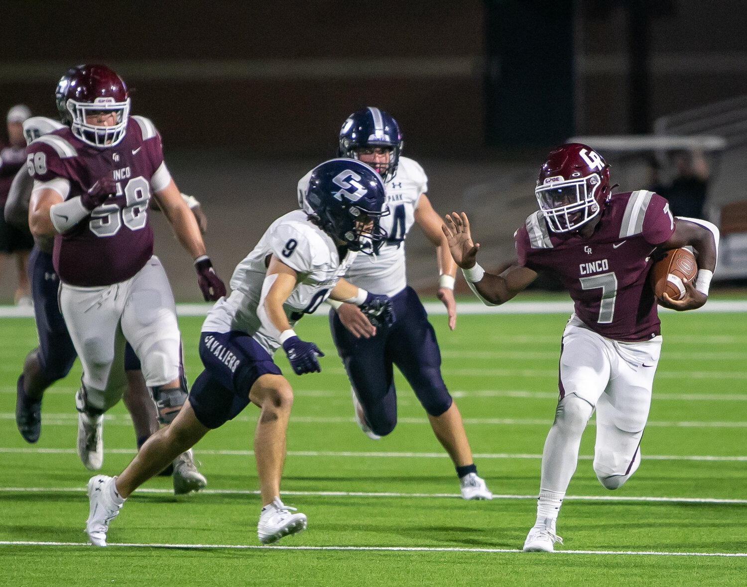 Marcus Gadlin stiff arms a College Park player during Friday's game between Cinco Ranch and College Park at Rhodes Stadium.