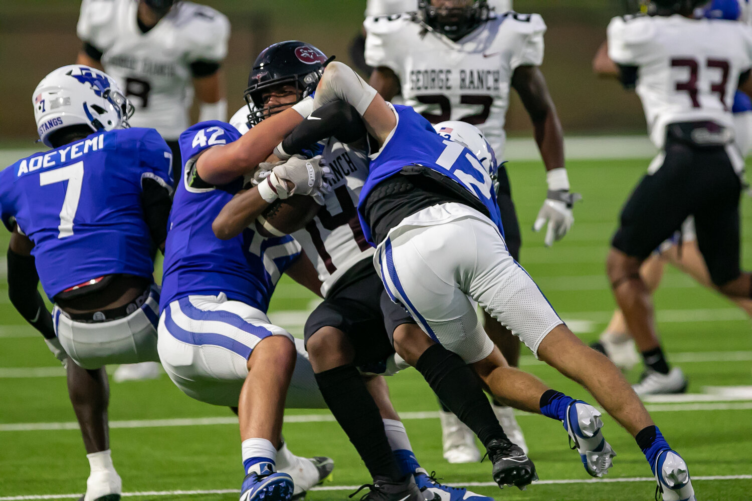 Duke Hammond and Josiah Rodriguez make a tackle during Thursday's game between Taylor and George Ranch at Rhodes Stadium.