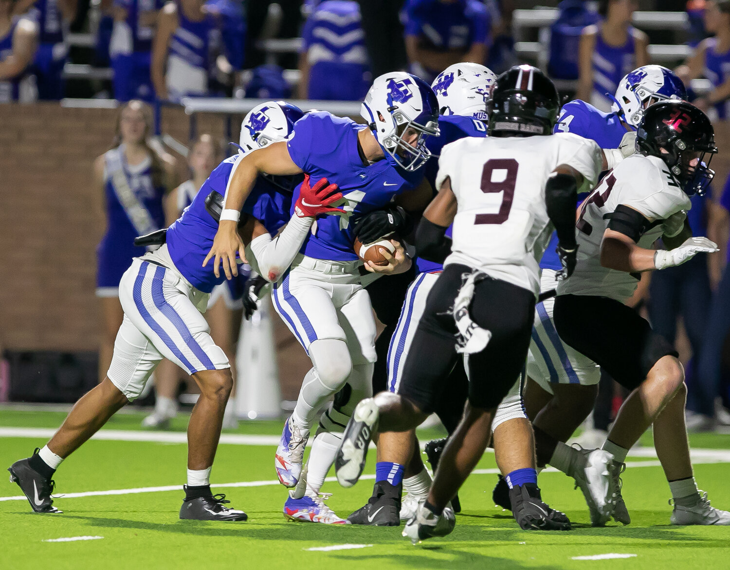 Daniel Bruns gets pushed towards the endzone during Thursday's game between Taylor and George Ranch at Rhodes Stadium.