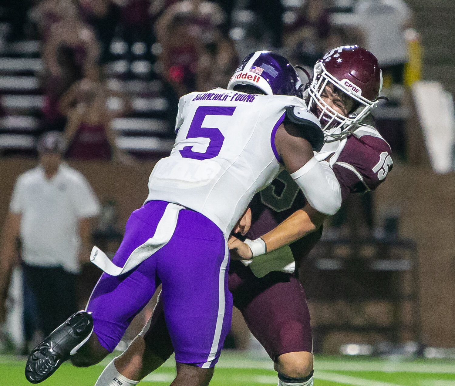 Davis Roup takes a hit from Kevin Schneider-Young after throwing a pass during Friday's District 19-6A game between Cinco Ranch and Morton Ranch on Friday at Rhodes Stadium.