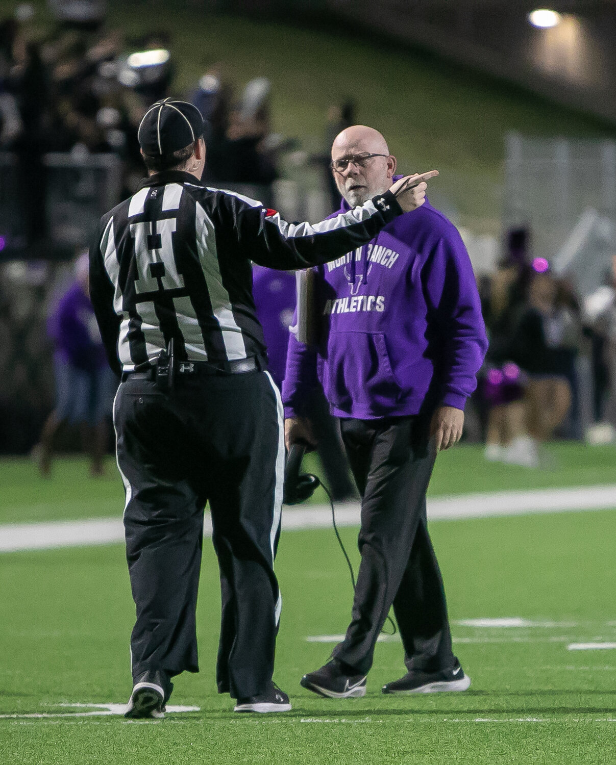 Morton Ranch head coach Ron Counter talks to a referee during Thursday's game between Jordan and Morton Ranch at Legacy Stadium.