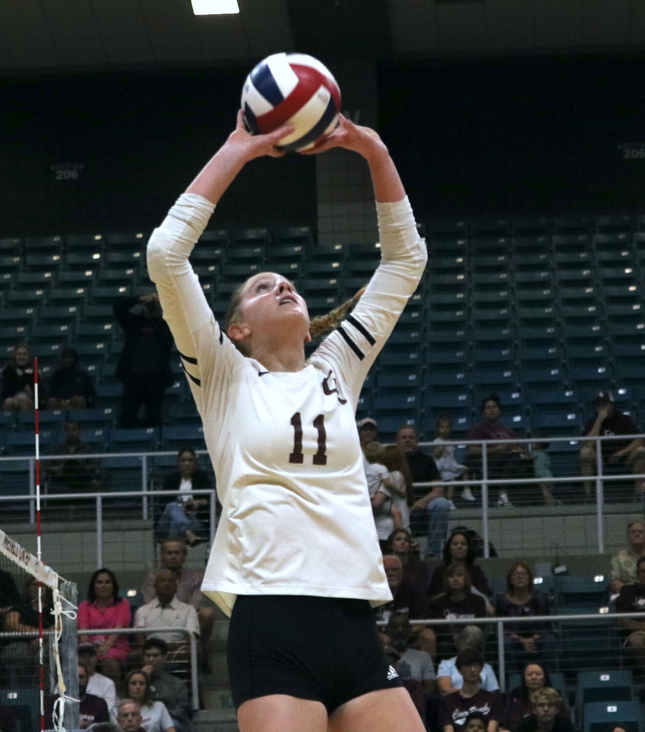 Kassie O’Brien sets the ball during Tuesday’s match between Cinco Ranch and Cy-Fair at the Merrell Center.