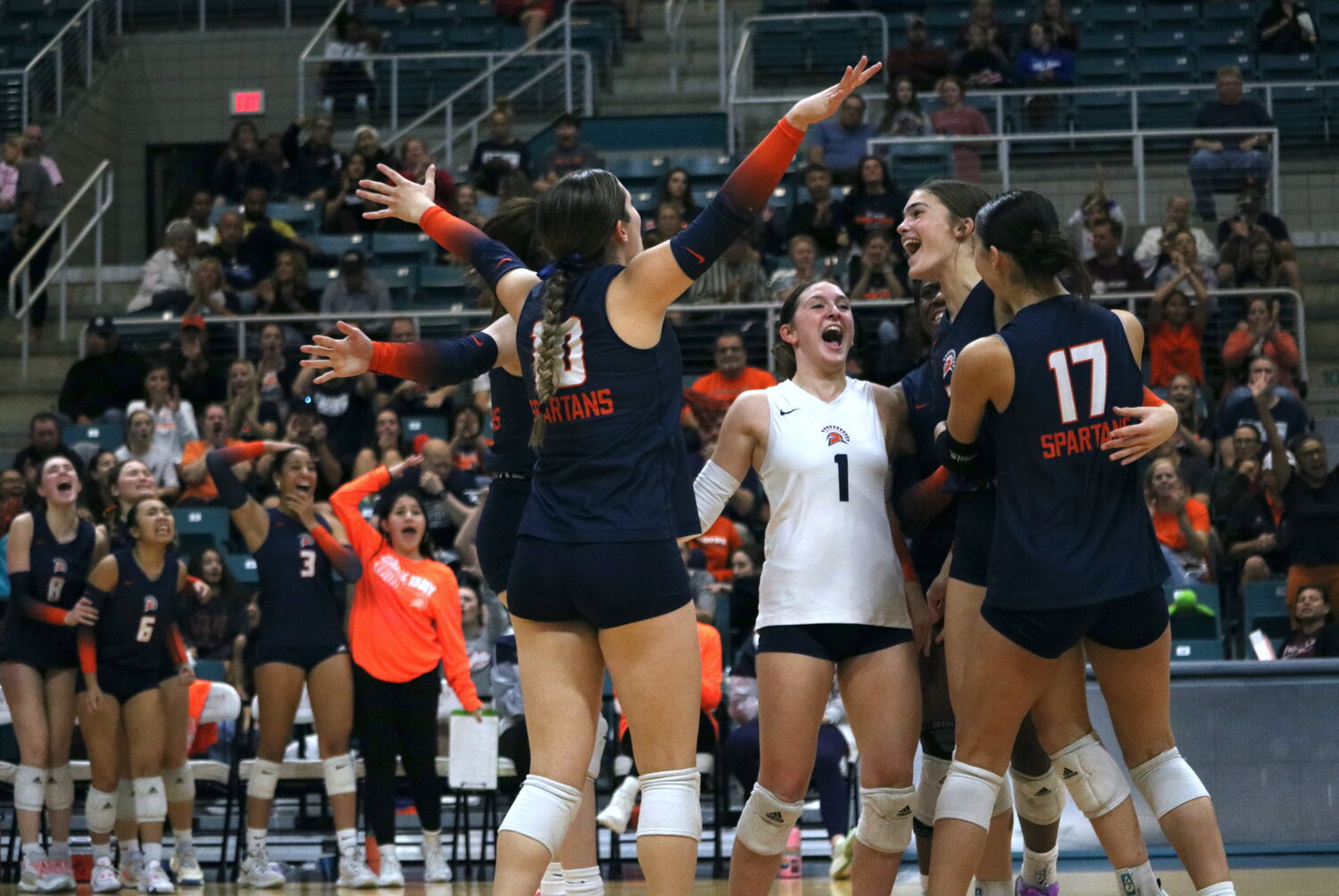 Seven Lakes players celebrate after winning a set during Tuesday’s match between Seven Lakes and Tompkins at the Merrell Center.