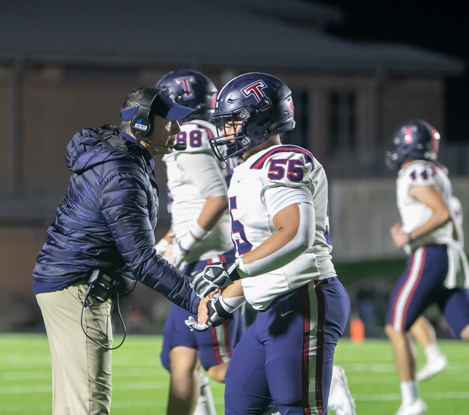 Tompkins head coach Todd McVey celebrate the Tompkins offense after a touchdown during Friday's game between Tompkins and Ridge Point at Hall Stadium.