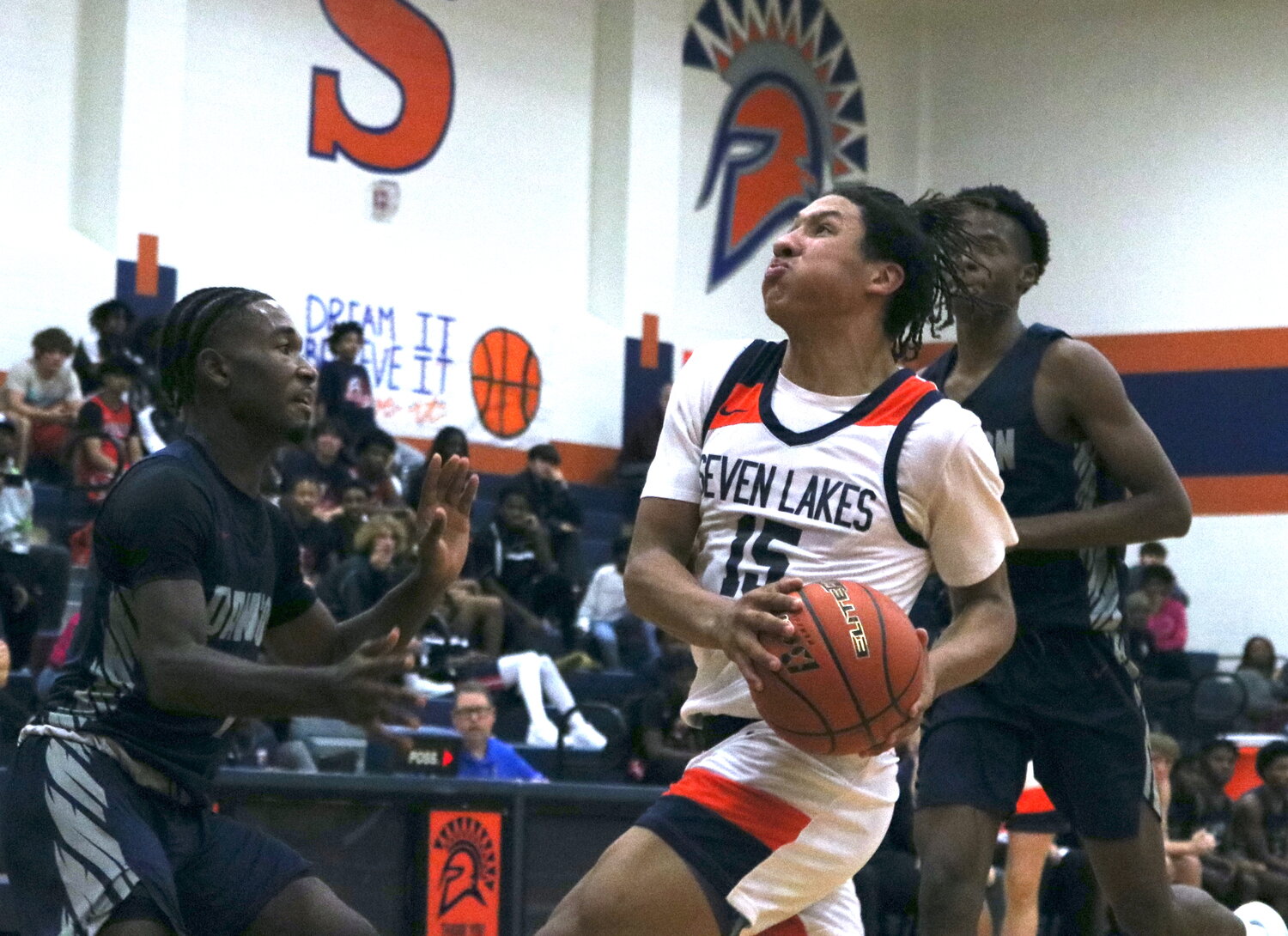 Isaiah Santos drives to the basket during Monday's game between Seven Lakes and Pearland Dawson at the Seven Lakes gym.