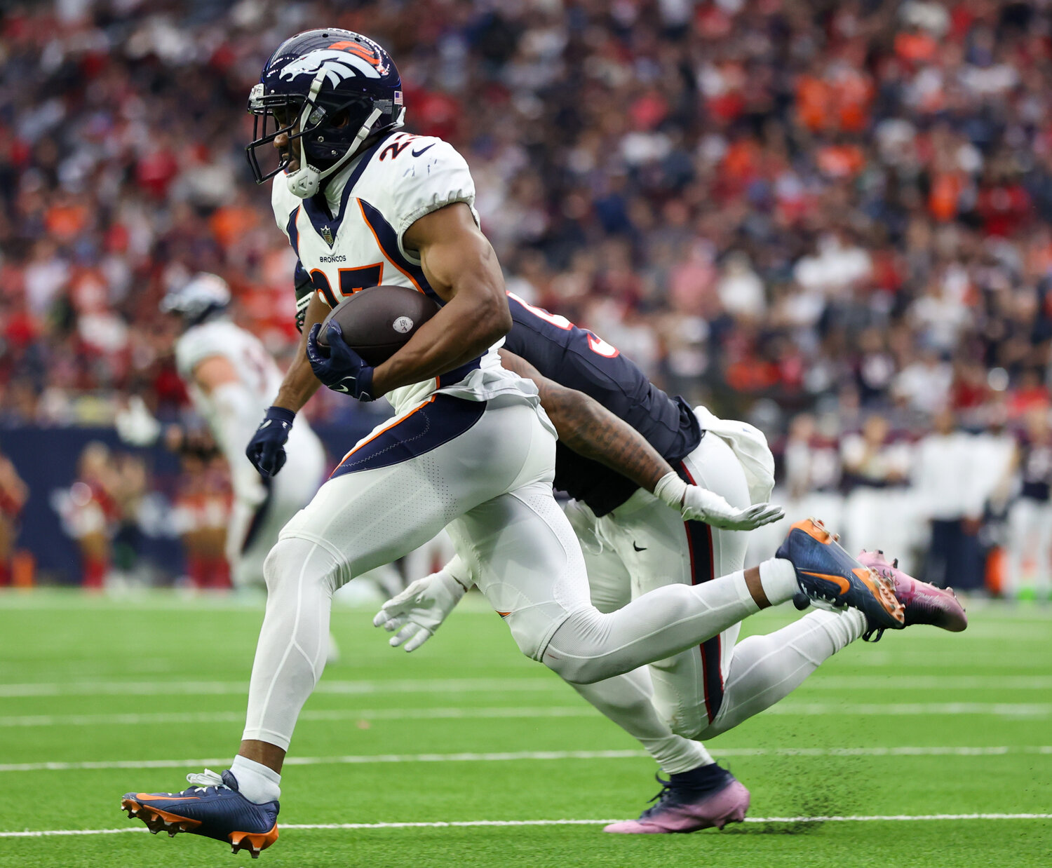 Broncos cornerback Fabian Moreau (23) returns an intercepted pass on a two-point conversion attempt during an NFL game between the Texans and the Broncos on December 3, 2023 in Houston. The Texans won, 22-17.