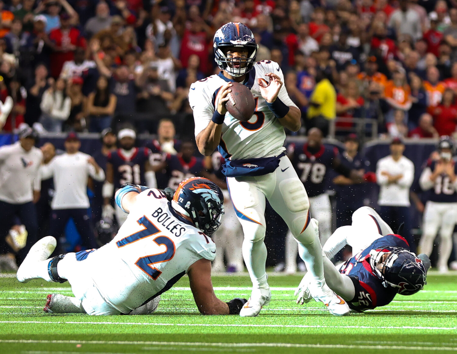 Broncos quarterback Russell Wilson (3) shakes off Texans defensive end Jonathan Greenard (52) to get off a pass that was intercepted in the end zone, sealing a 22-17 win for the Texans in an NFL game on December 3, 2023 in Houston. The Texans won, 22-17.
