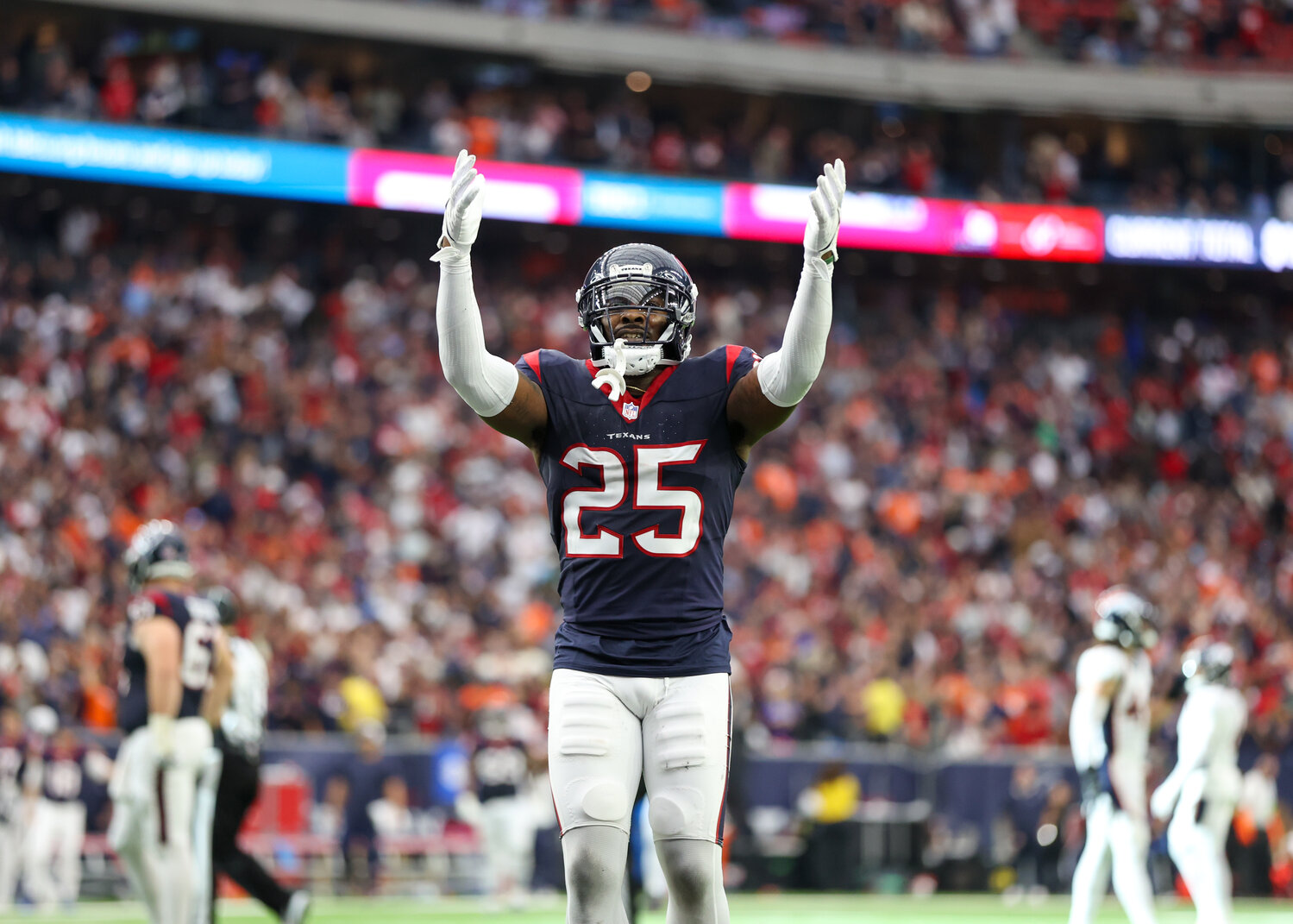 Texans cornerback Desmond King II (25) gestures to the fans after Houston intercepted a pass from Broncos quarterback Russell Wilson in the end zone in the final seconds of the game to seal a 22-17 victory in an NFL game on December 3, 2023 in Houston.