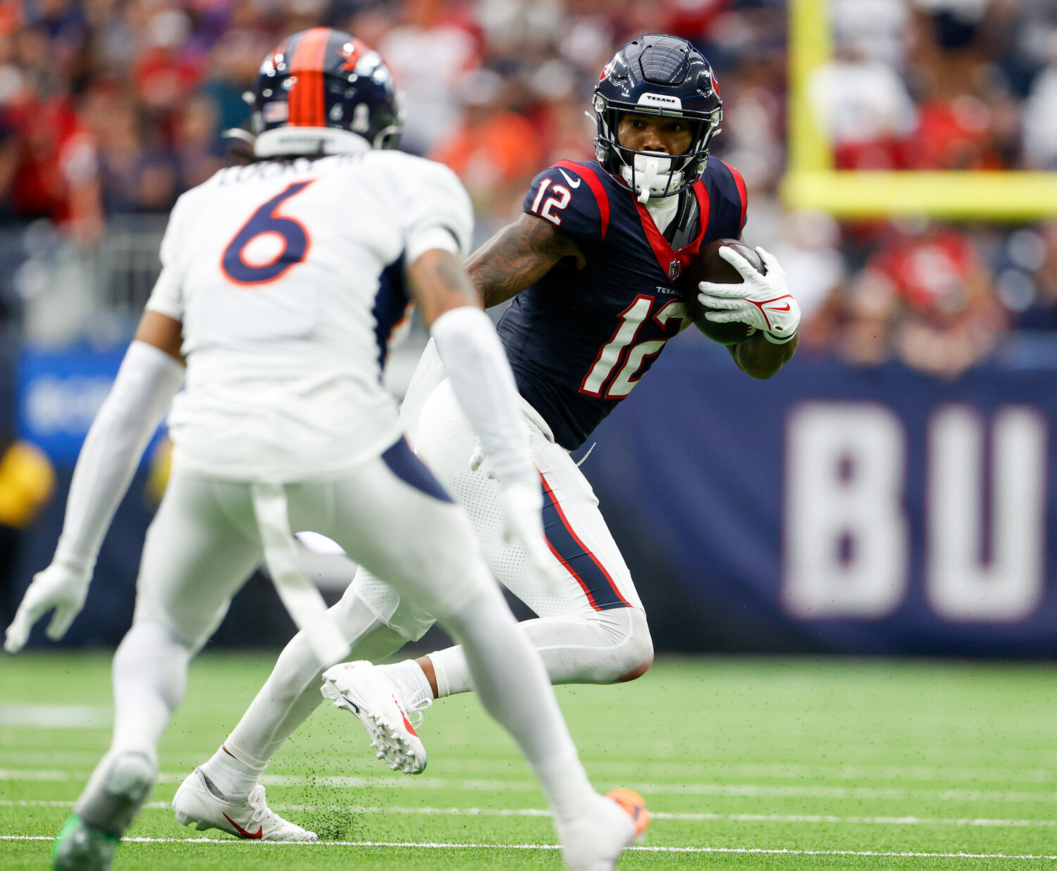 Texans wide receiver Nico Collins (12) carries the ball after a catch during an NFL game between the Texans and the Broncos on December 3, 2023 in Houston. The Texans won, 22-17.