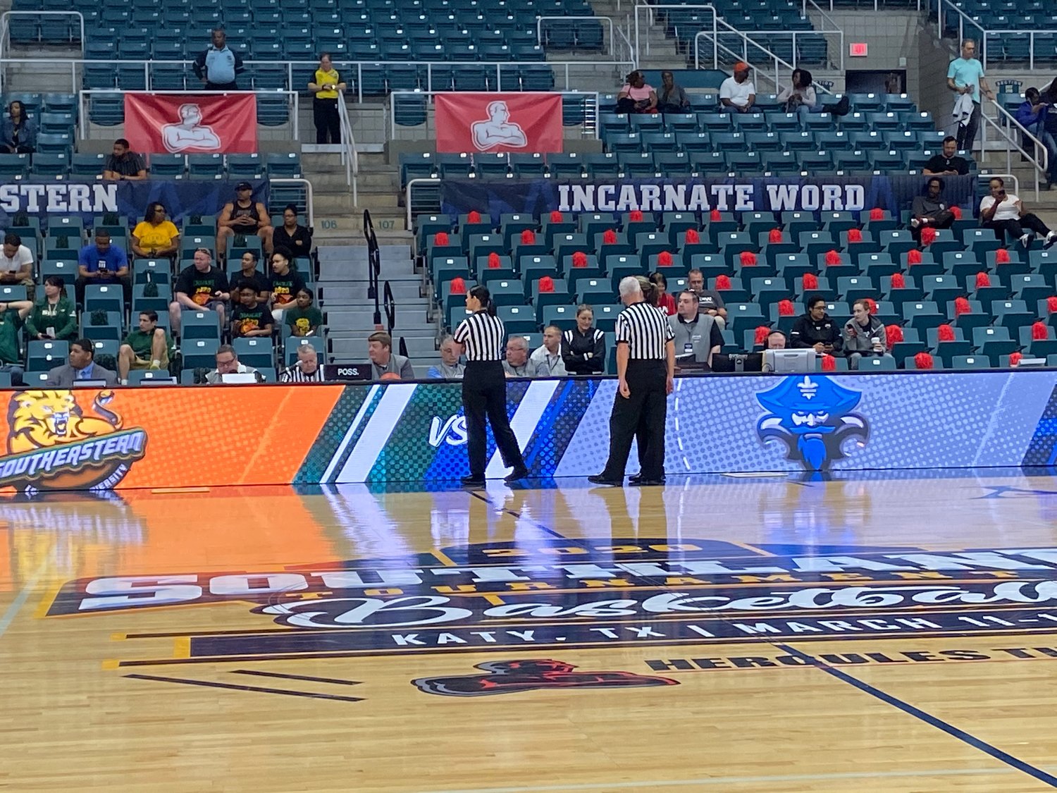 Game officials wait at the scorer's table to hear word on a decision from Southland Conference presidents prior to tip-off of the Southeastern Louisiana-New Orleans women's basketball game at the Merrell Center in Katy. It was ultimately decided to cancel the tournament.