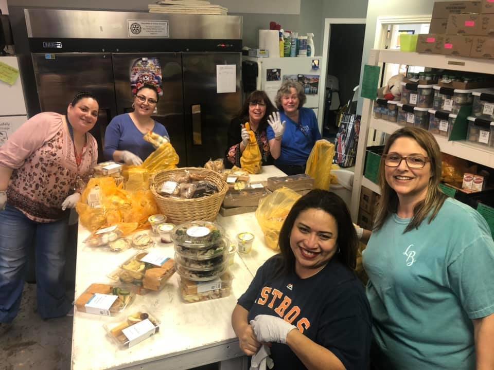 Katy Christian Ministries Executive Director Deysi Crespo (front in Astros T-shirt) and her staff and volunteers put together items for distribution to KCM clients. Like other nonprofits throughout the area, KCM has had to cancel or postpone fundraising activities during the COVID-19 pandemic.