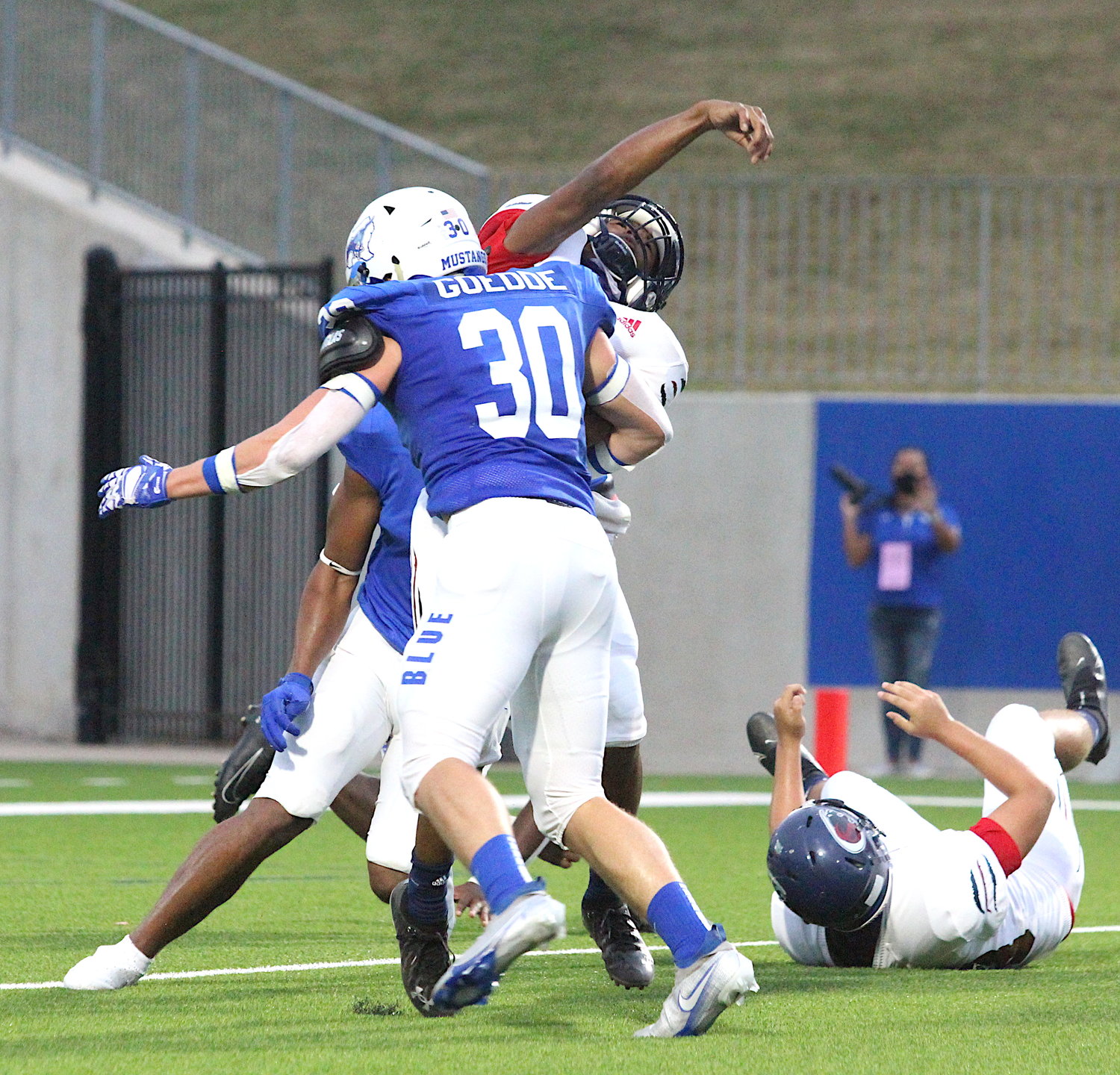 Taylor junior linebacker Nick Goedde gets to the Cy-Springs quarterback during their game Thursday at Legacy Stadium.