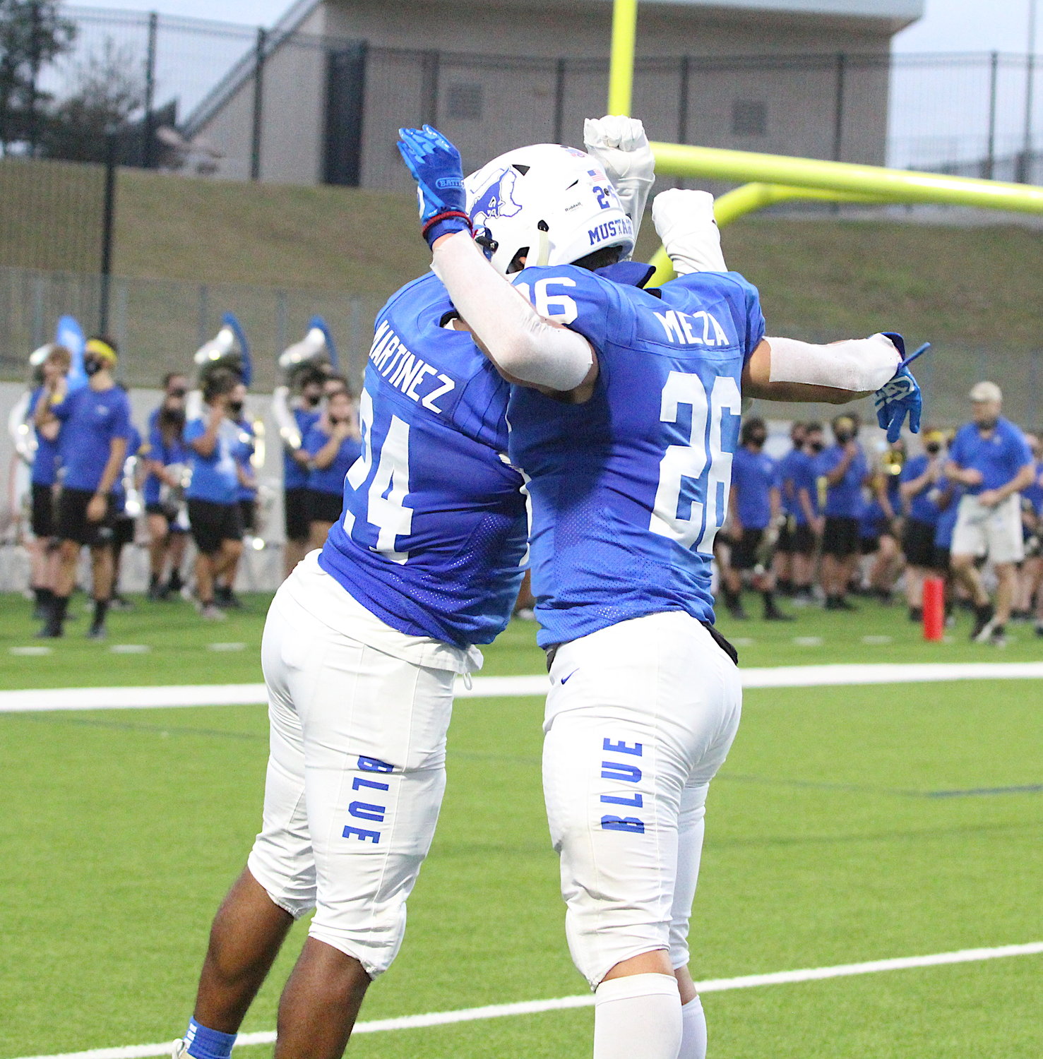 Taylor senior receiver Santana Martinez, left, and sophomore running back Andrew Meza celebrate Martinez's touchdown during Thursday's game against Cy-Springs at Legacy Stadium.