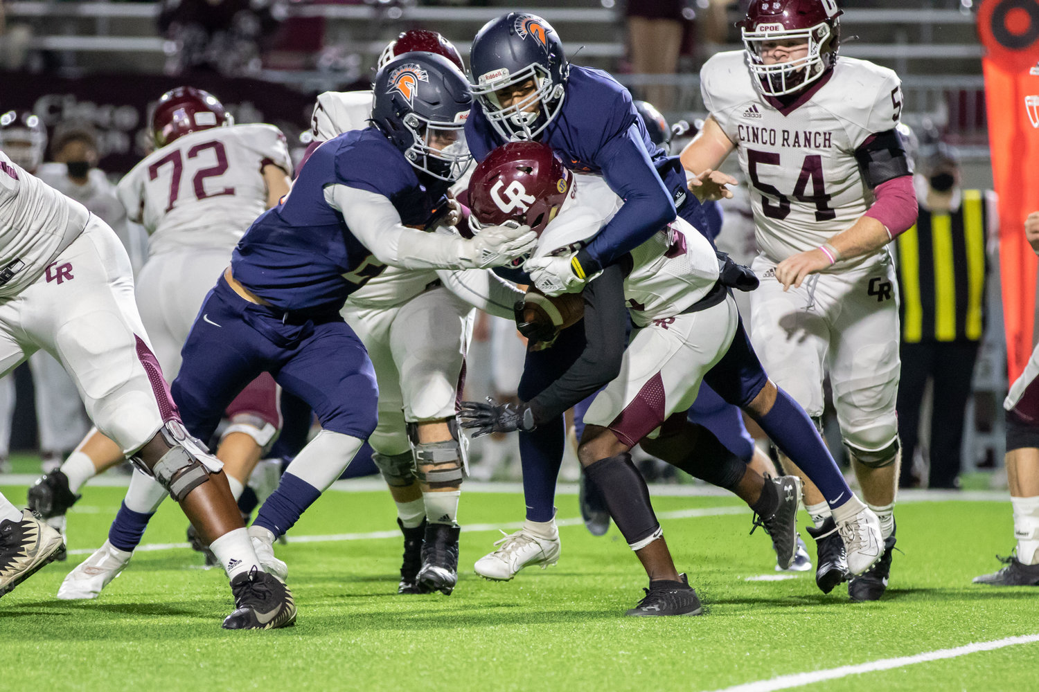 Seven Lakes defenders take down a Cinco Ranch ballcarrier during the Spartans' win over Cinco Ranch on Dec. 4 at Legacy Stadium.