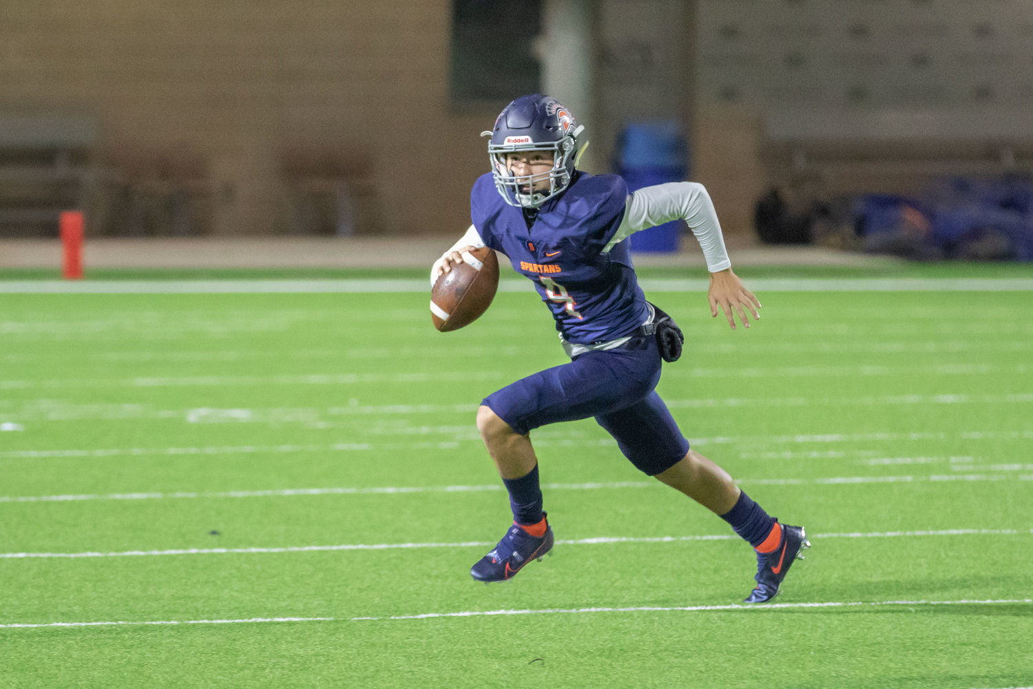 Seven Lakes senior quarterback Cristian Beltran scrambles for the Spartans during their win over Cinco Ranch on Dec. 4 at Legacy Stadium.