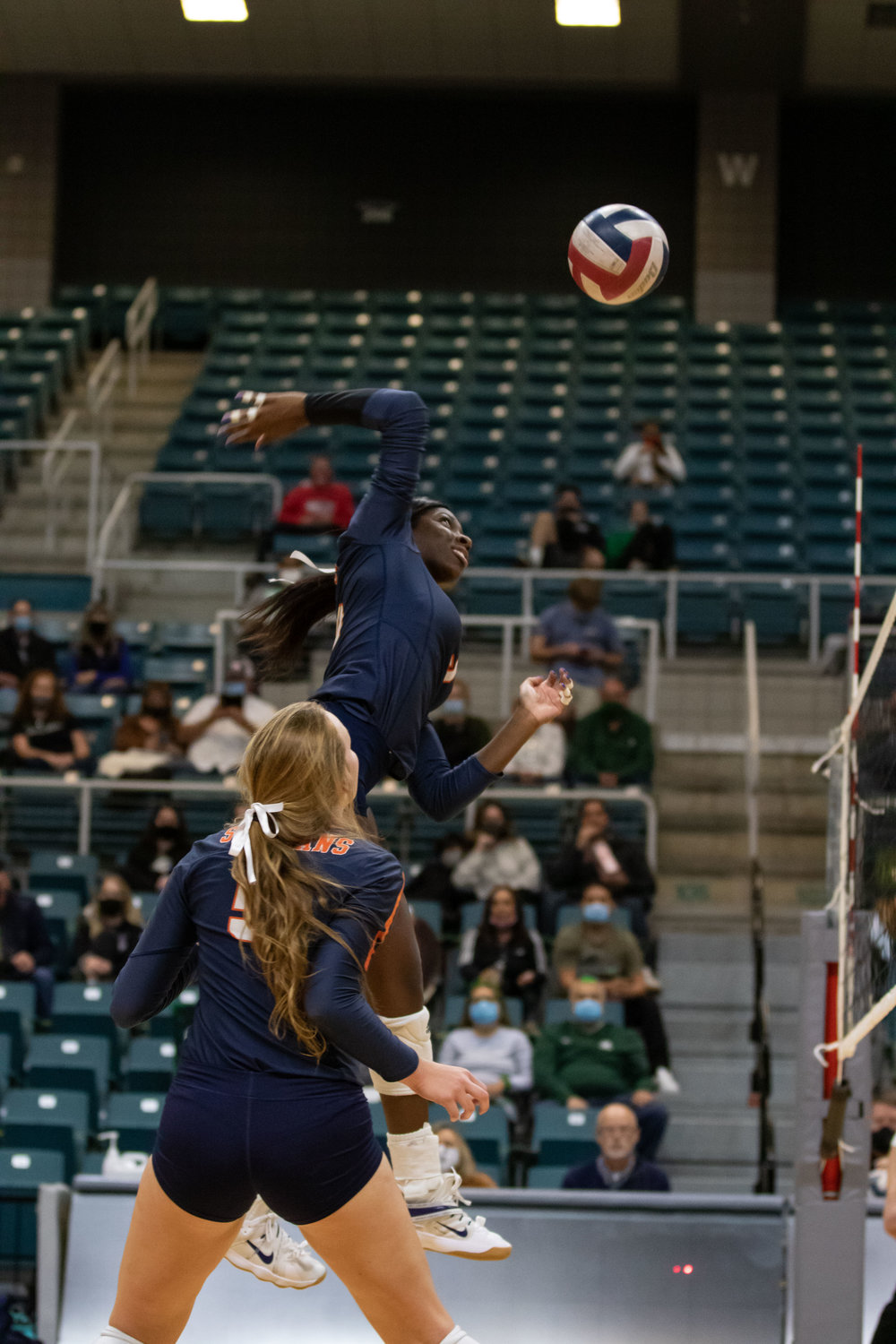Seven Lakes senior Mayo Olibale swings on the attack during the Spartans' 3-2 win over San Antonio Reagan in their Class 6A state semifinal on Dec. 7 at the Merrell Center.