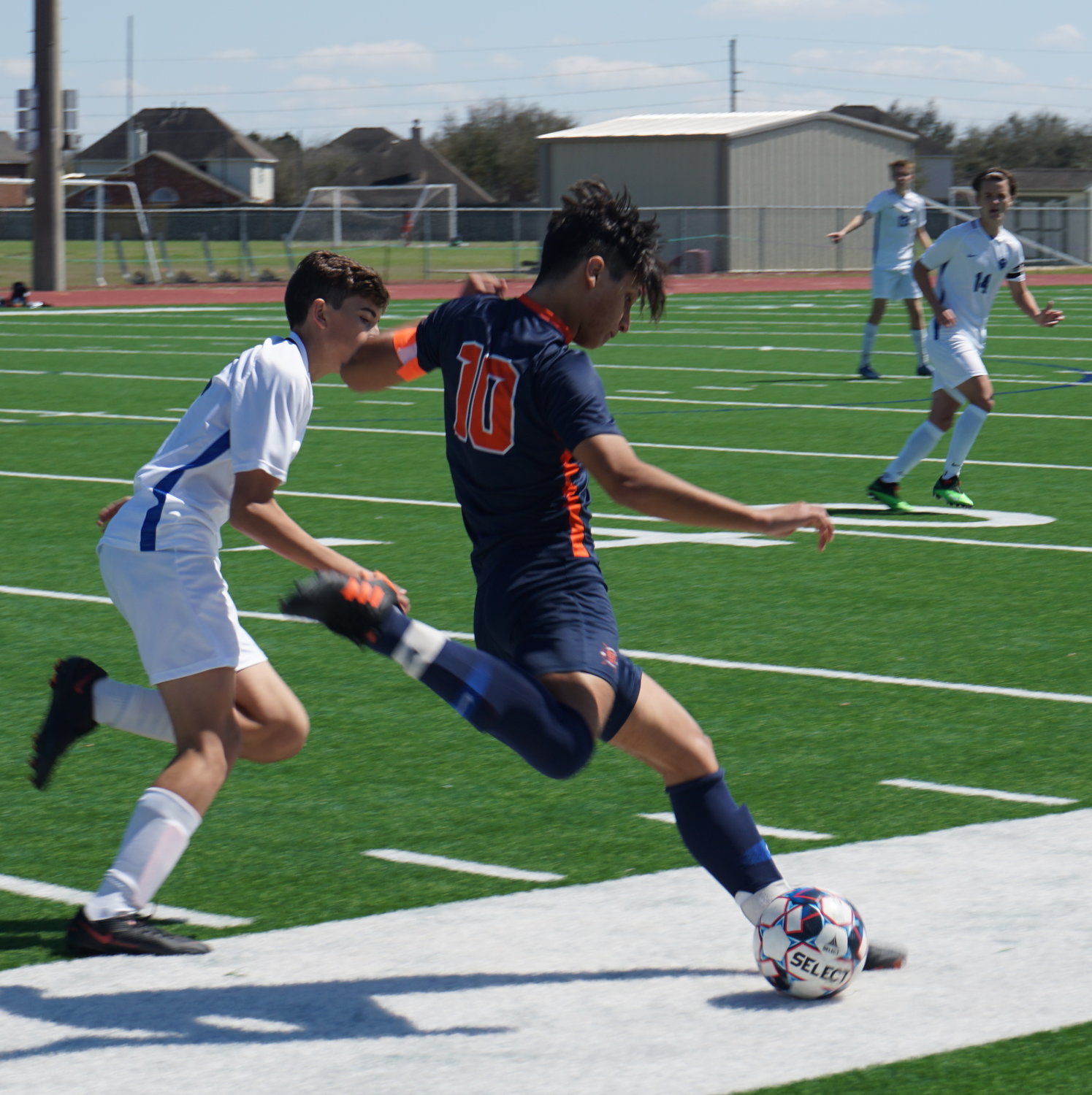 Seven Lakes senior midfielder Vicente Garcia looks to kick the ball downfield during a game against Taylor on Saturday, March 6, at Seven Lakes High.