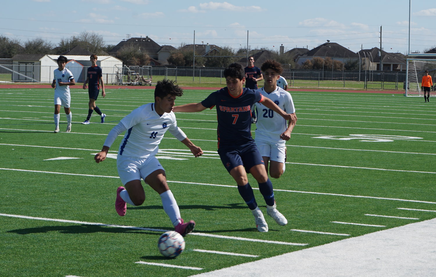 Seven Lakes senior midfielder Diego Lazo (7) and Taylor junior Gabriel Stephano Zagastizabal (11) pursue the ball during their game Saturday, March 6, at Seven Lakes High.