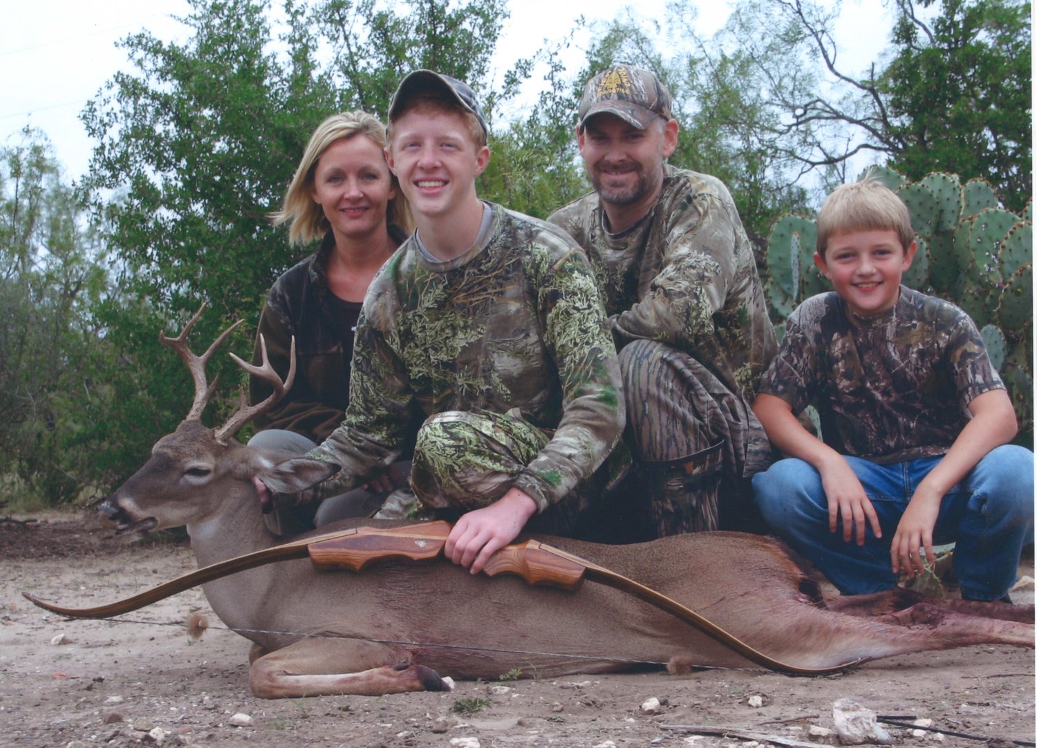 Dalton Patrick Rosser (center) was an avid outdoorsman. Here he poses with his family after harvesting a deer with his Palmer recurve bow at First Point Bowhunting Ranch.