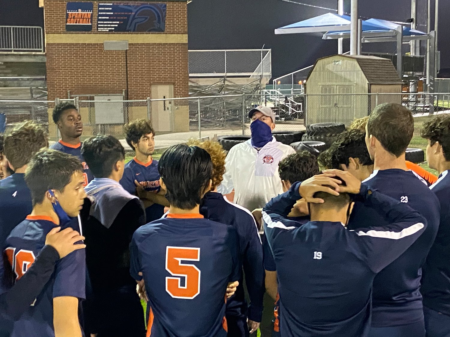 Seven Lakes boys soccer coach Jimmy Krueger talks to his players after their 2-1 win over Cinco Ranch on Friday, March 12, that secured the program's second straight district title and third in five years.