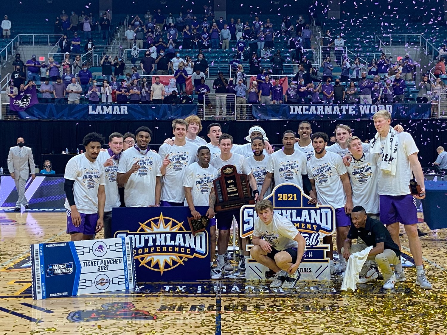 Abilene Christian players pose for a photo after winning the Southland Conference men's basketball tournament for the second straight season on Saturday, March 13, at the Merrell Center