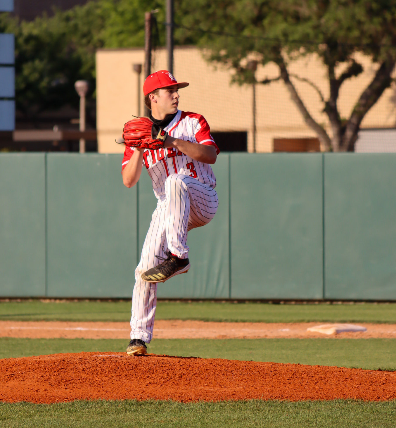 Katy High senior Caleb Matthews prepares to deliver a pitch against Seven Lakes on Tuesday, April 20, at Katy High.
