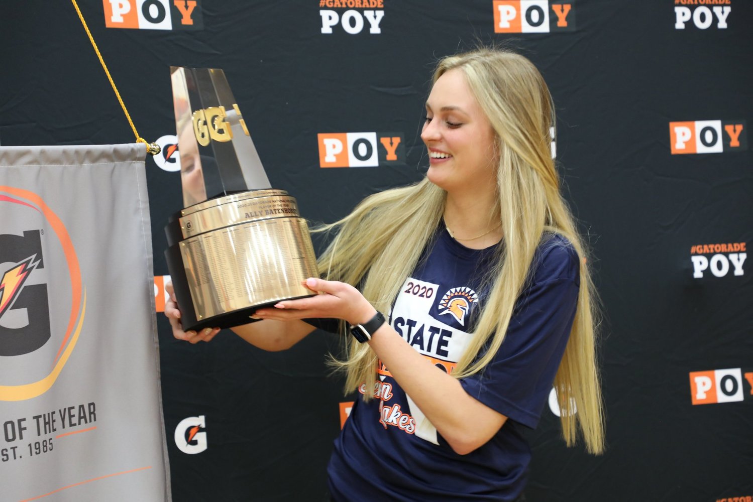 Former Seven Lakes star Ally Batenhorst looks on at the 2020-21 Gatorade Volleyball National Player of the Year trophy that she was honored with on Wednesday at Seven Lakes High School.