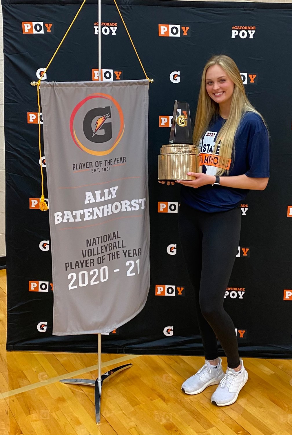 Former Seven Lakes star Ally Batenhorst poses for a photo with the 2020-21 Gatorade Volleyball National Player of the Year trophy that she was honored with on Wednesday at Seven Lakes High School.