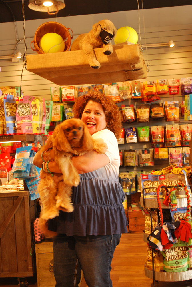 Patsy McGirl is the owner of Patsy’s Pet Market. Pictured here with a client’s pet, Patsy offers a variety of services at her shop including healthy food and treats, grooming and pet training workshops.