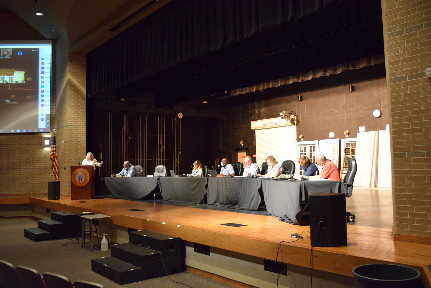 Members of the Royal ISD Board of Trustees met July 19 at the district’s Performing Arts Center which is attached to Royal High School. During the meeting, they heard from Associate Superintendent Kendra Strange (at podium) regarding the district’s test scores which she said lowered during the 2020-21 school year, but on a level similar to that seen across the state from remote schooling during the pandemic. Seated from left to right: Position 4 Trustee Nathaniel Richardson, Jr., Position 5 Trustee Melissa Woods, President and Position 3 Trustee Michael Glover, Superintendent Rick Kershner, Position 2 Trustee Cheri Fontenot, Position 7 Trustee Rose Jones and Position 6 Trustee Elton Foster.