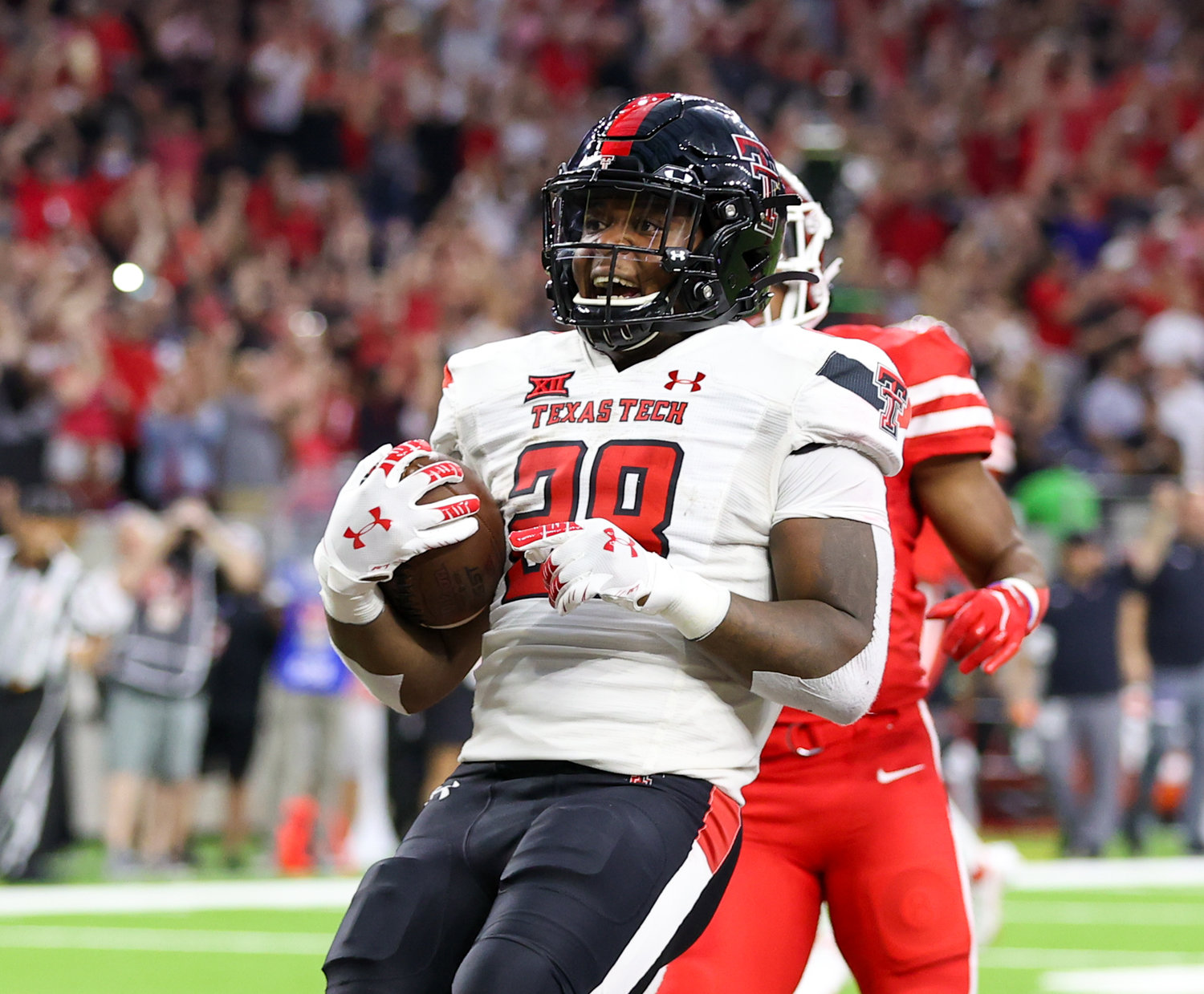 Texas Tech Red Raiders running back Tahj Brooks (28) carries the ball into the end zone on a 41-yard touchdown run during an NCAA football game between Houston and Texas Tech on September 4, 2021 in Houston, Texas.