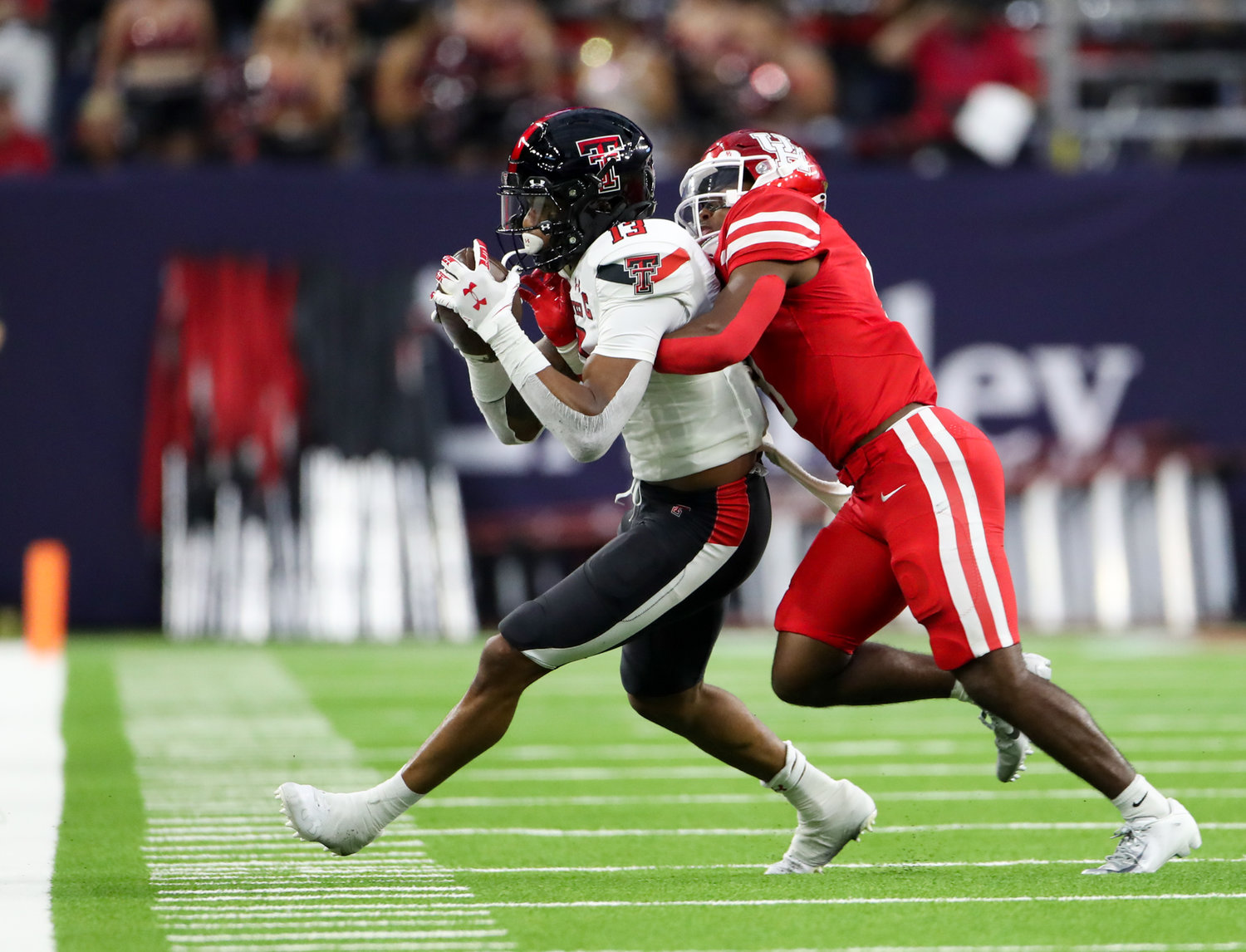 Houston Cougars cornerback Marcus Jones (8) pushes Texas Tech Red Raiders wide receiver Erik Ezukanma (13) out of bounds after a reception during an NCAA football game between Houston and Texas Tech on September 4, 2021 in Houston, Texas.
