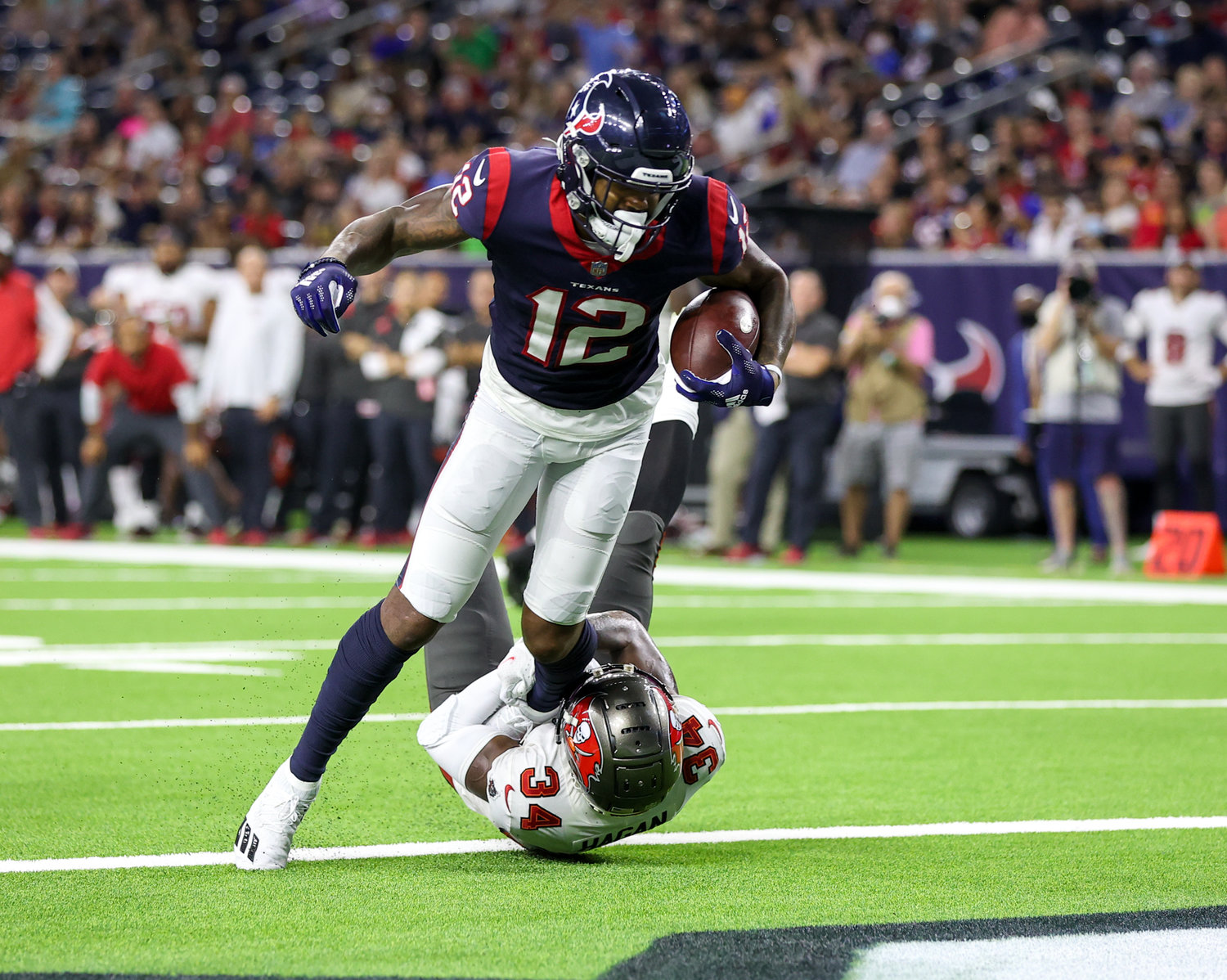 Houston Texans wide receiver Nico Collins (12) scores on an 11-yard pass from quarterback Davis Mills (10) during an NFL preseason game between the Houston Texans and the Tampa Bay Buccaneers on August 28, 2021 in Houston, Texas.