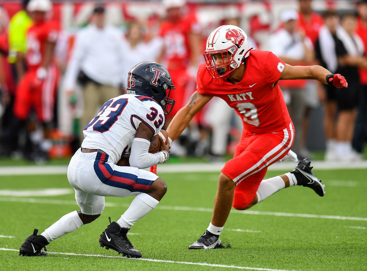 Katy, Tx. Oct. 1, 2021: Katy's #9 Antonio Silva makes the stop on Tompkins #33 Julius Mourning during a game between Katy Tigers and Tompkins Falcons at Legacy Stadium in Katy. (Photo by Mark Goodman / Katy Times)