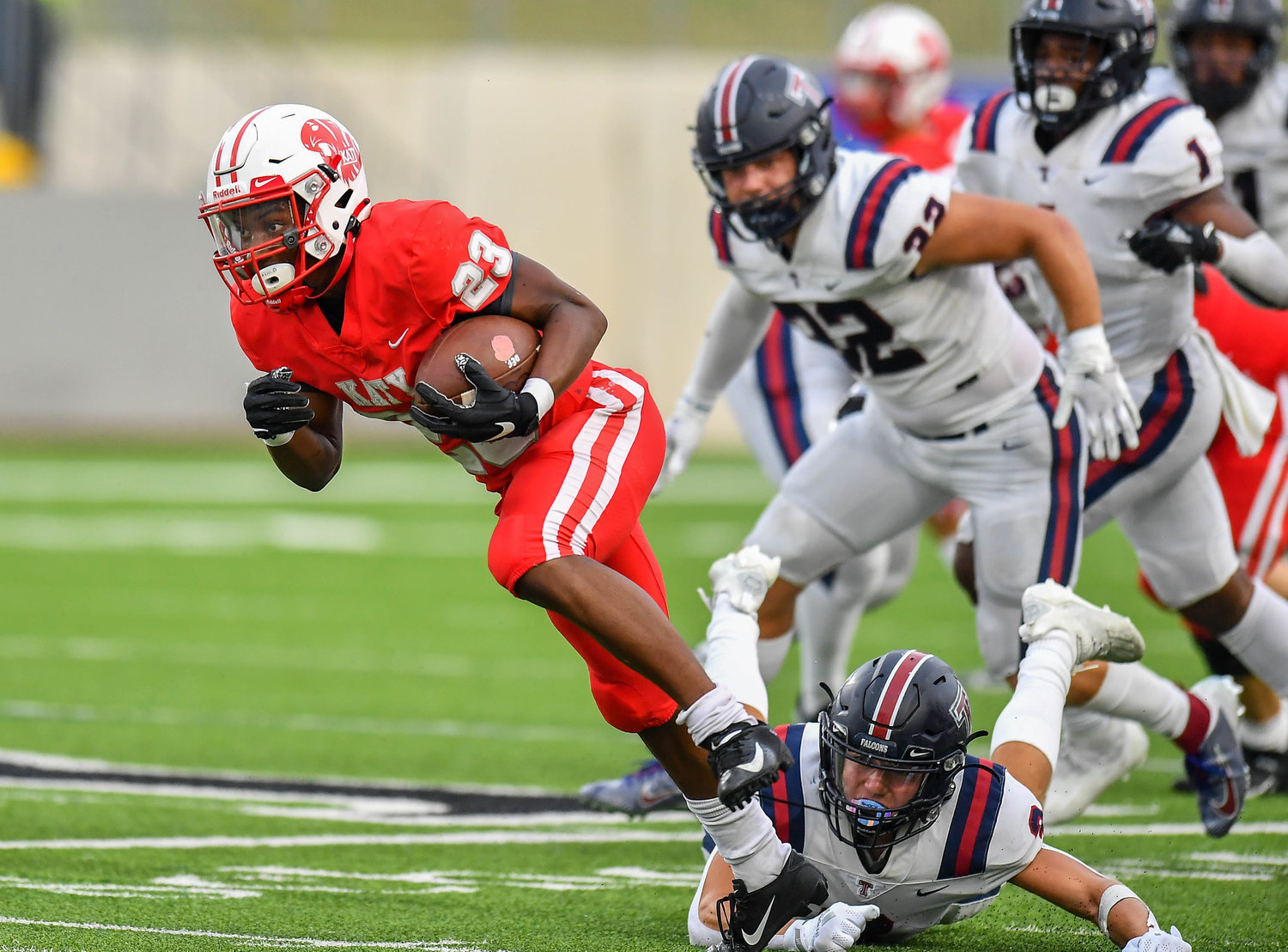 Katy, Tx. Oct 1, 2021: Katy's #23 Seth Davis carries the ball breaking tackles at mid field for a TD during a game between Katy Tigers and Tompkins Falcons at Legacy Stadium in Katy. (Photo by Mark Goodman / Katy Times)