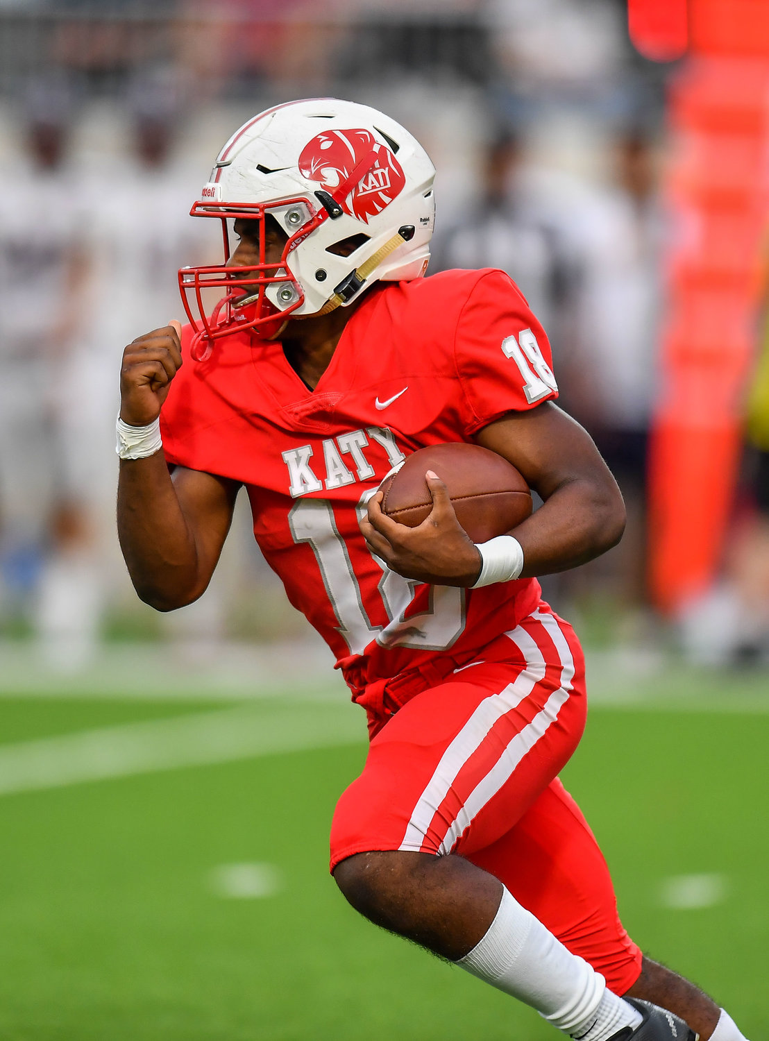 Katy, Tx. Oct 1, 2021: Katy's #18 Dallas Glass carries the ball picking up a first down during a game between Katy Tigers and Tompkins Falcons at Legacy Stadium in Katy. (Photo by Mark Goodman / Katy Times)