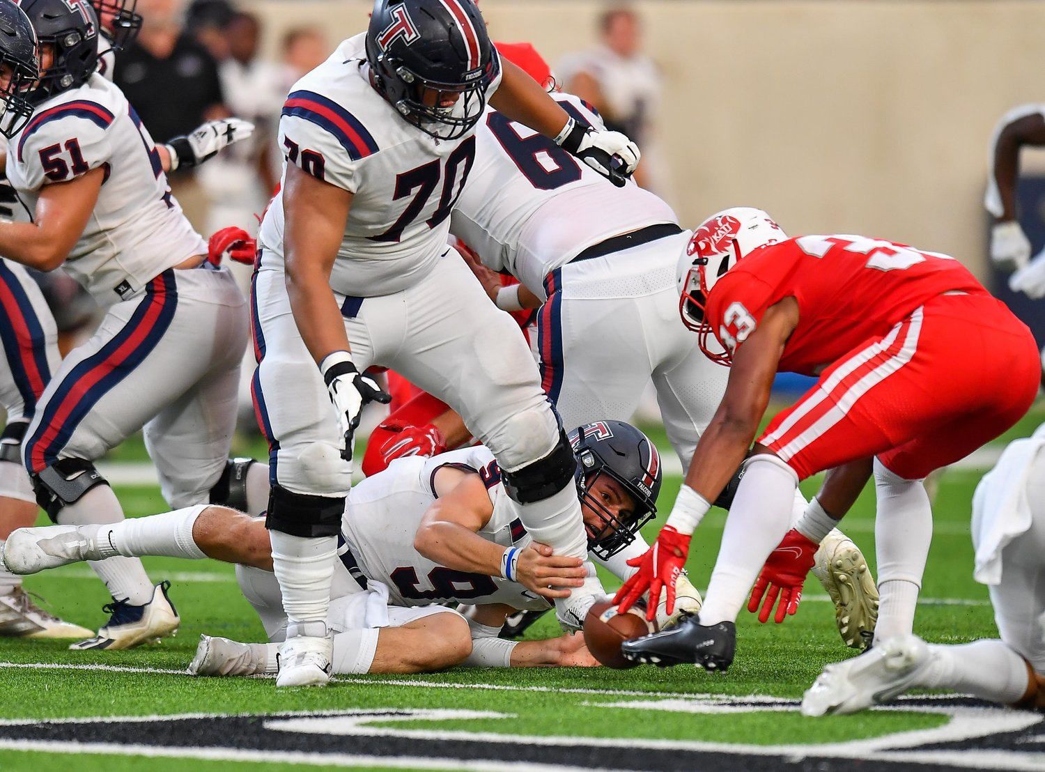 Katy, Tx. Oct 1, 2021:  A Tompkins fumble leads to a Katy recovery during a conference game between Katy Tigers and Tompkins Tompkins Falcons at Legacy Stadium. (Photo by Mark Goodman / Katy Times)