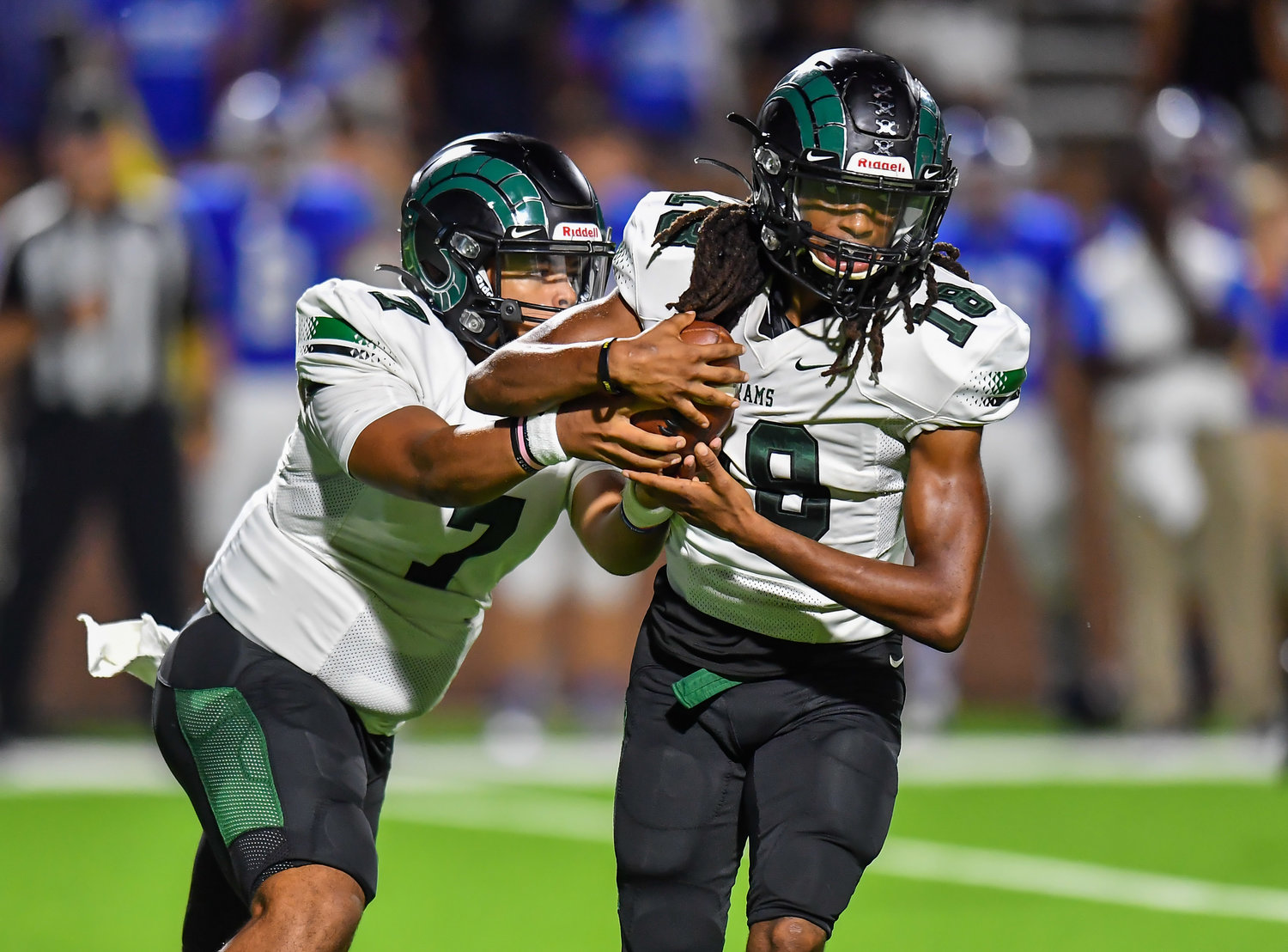 Katy, Tx. Oct 15, 2021: Mayde Creeks Jaylen Bragg #7 hands the ball off to Mayde Creeks Quintin Davis #18 during a conference game between Mayde Creek and Katy Taylor at Rhodes Stadium. (Photo by Mark Goodman / Katy Times)
