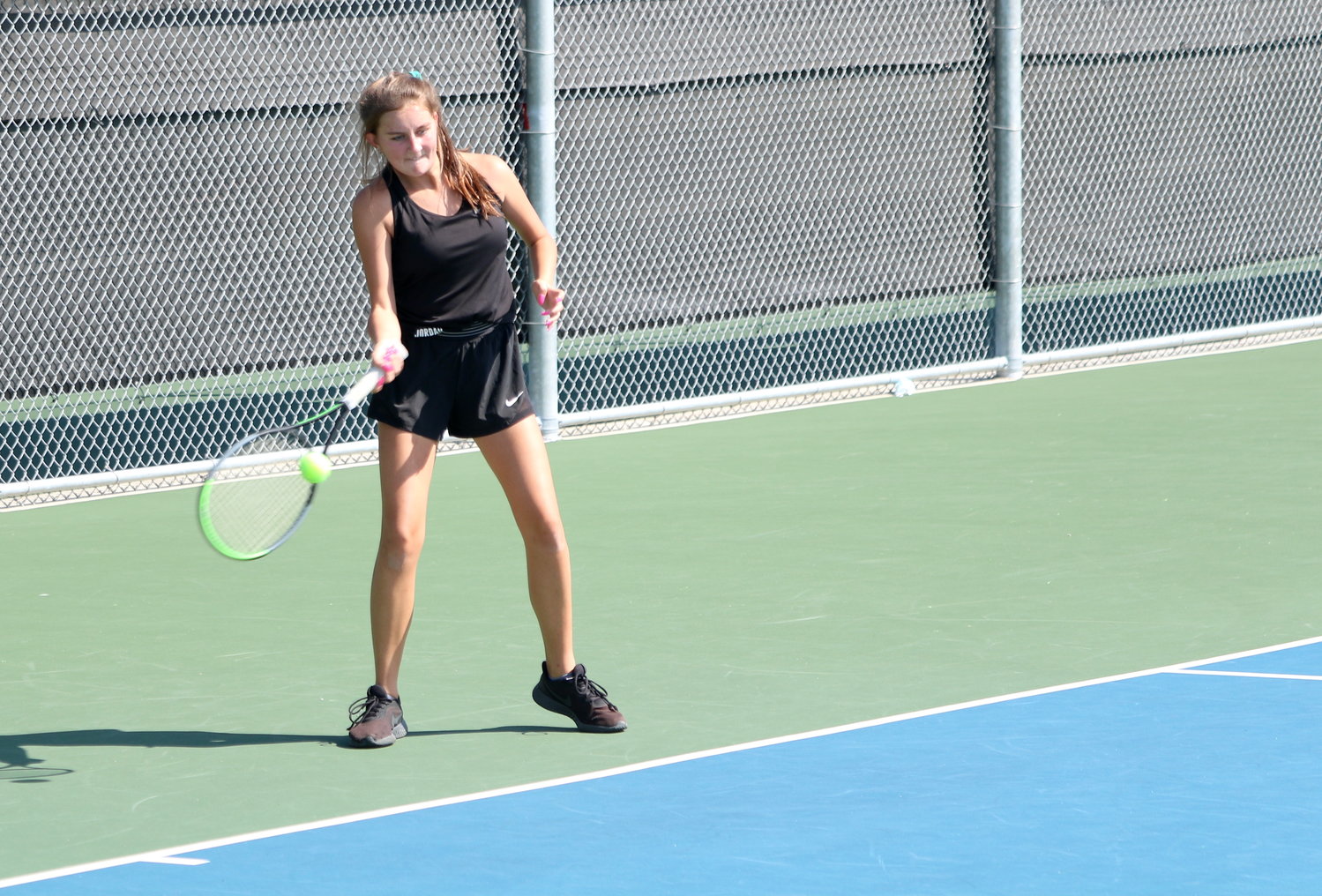Jordan’s Avery McKay hits a forehand during a regional quarterfinal match against Lake Creek on Tuesday.
