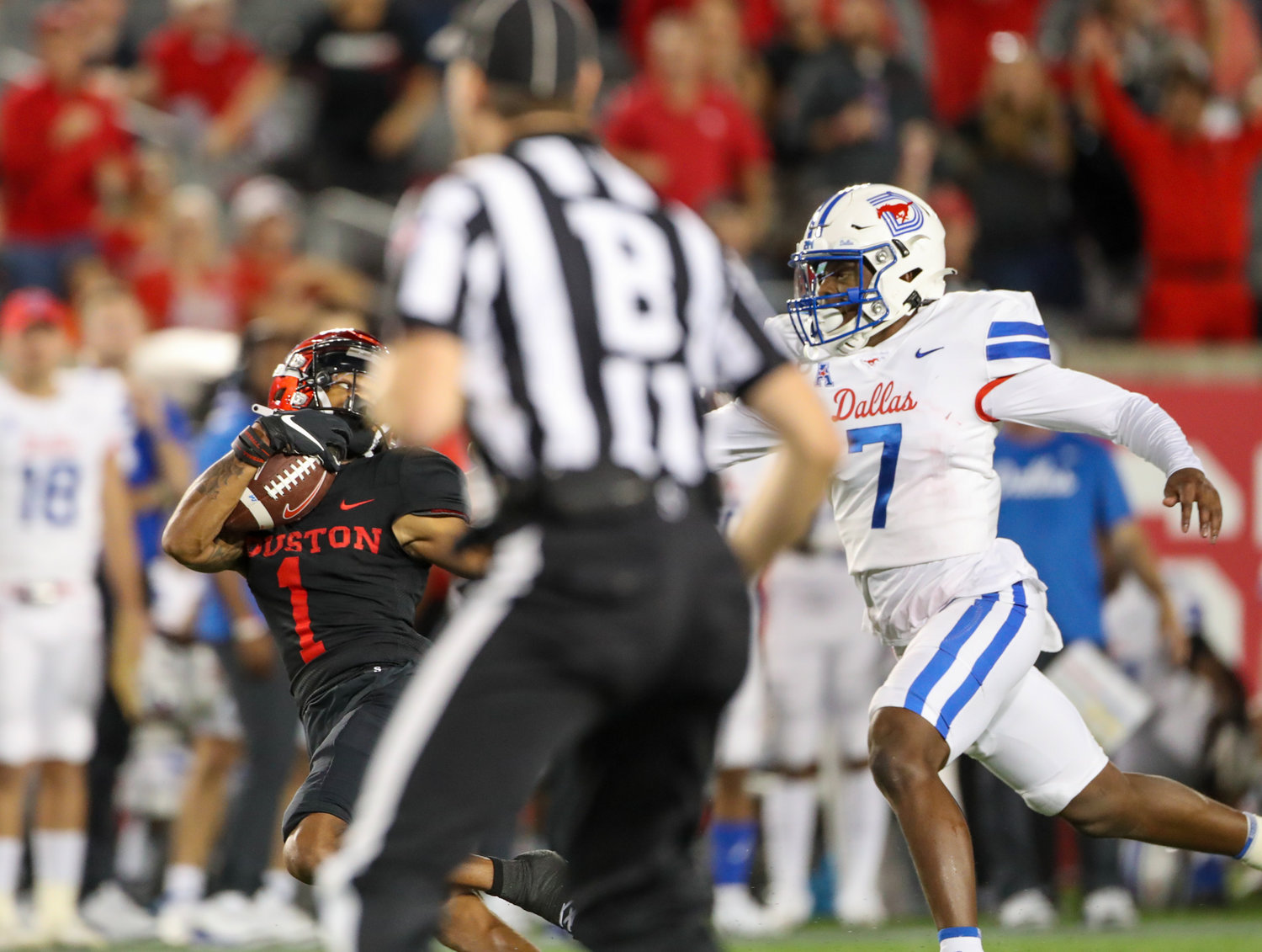 A game official gets in the way of a photographer’s shot of a reception by Houston Cougars wide receiver Nathaniel Dell (1)during an NCAA football game between Houston and SMU on October 30, 2021 in Houston, Texas.