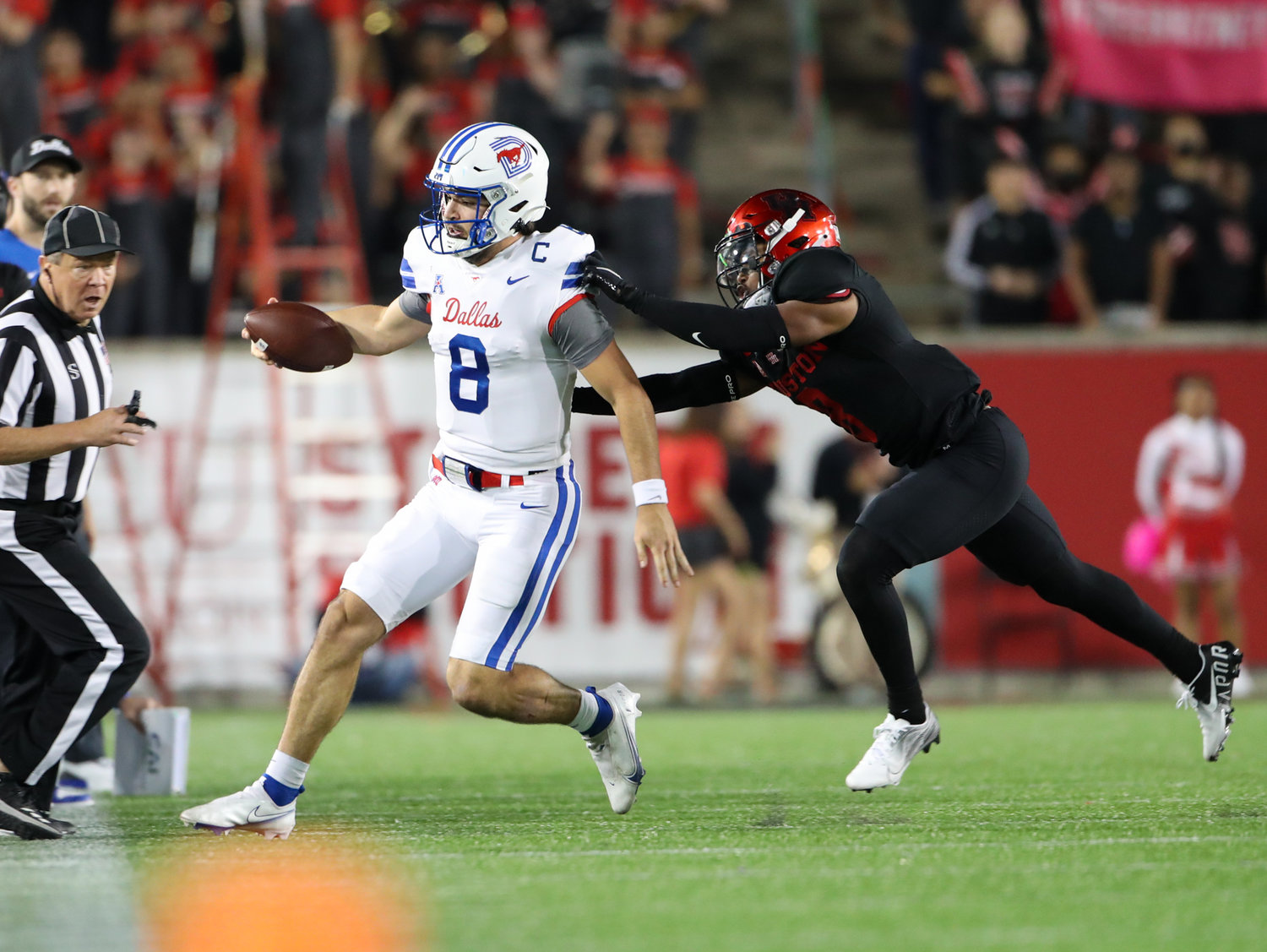 Houston Cougars cornerback Marcus Jones (8) runs SMU Mustangs quarterback Tanner Mordecai (8) out of bounds on a carry during an NCAA football game between Houston and SMU on October 30, 2021 in Houston, Texas.
